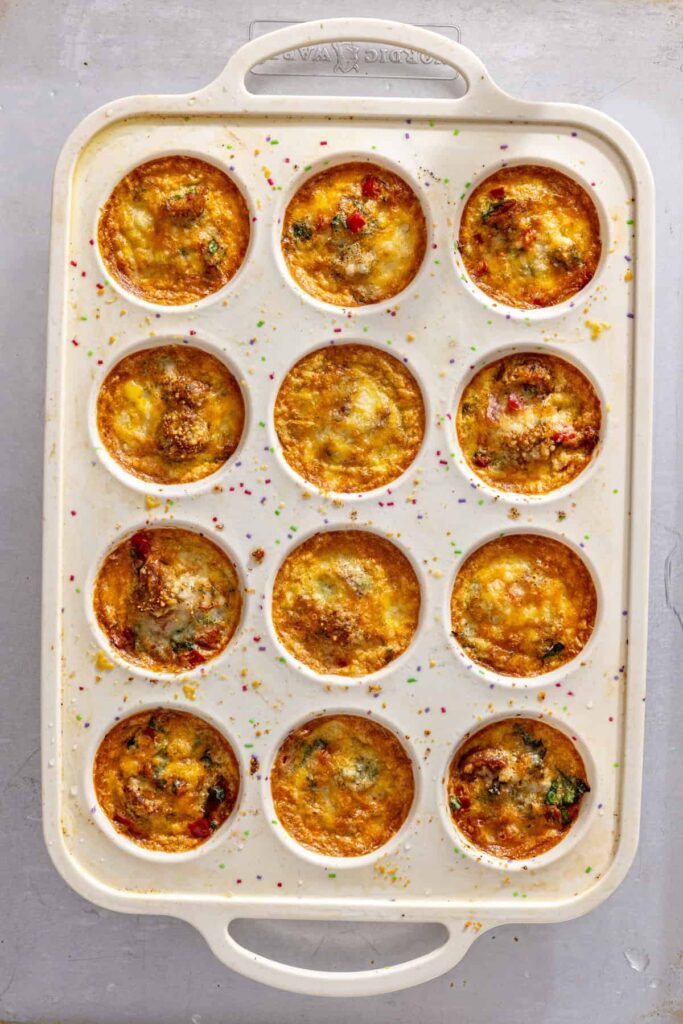 Golden baked gluten-free quiche cups fresh out of the oven in silicone muffin tin