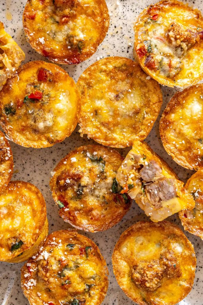 Close-up overhead view of gluten-free quiche cups on cake stand with rustic breakfast styling