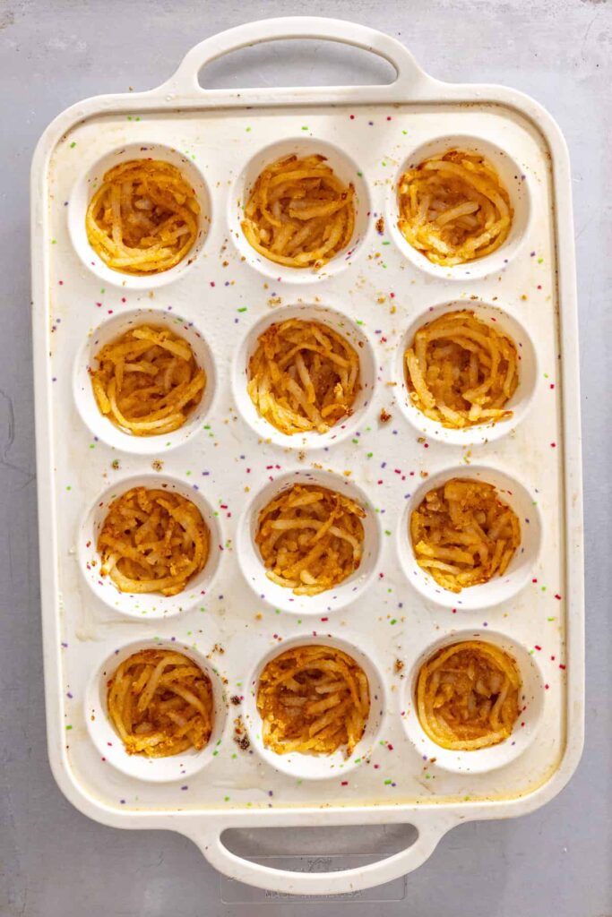 Crisped shredded potato bases baked for mini gluten-free quiche cups