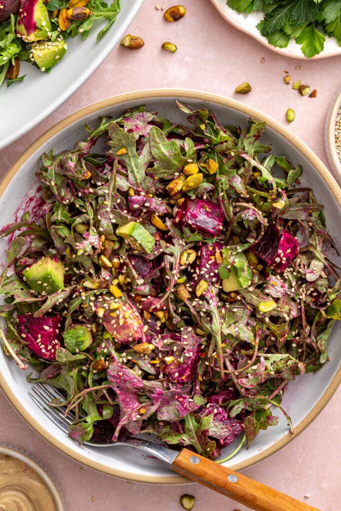 Roasted beet salad in a serving bowl on a styled table