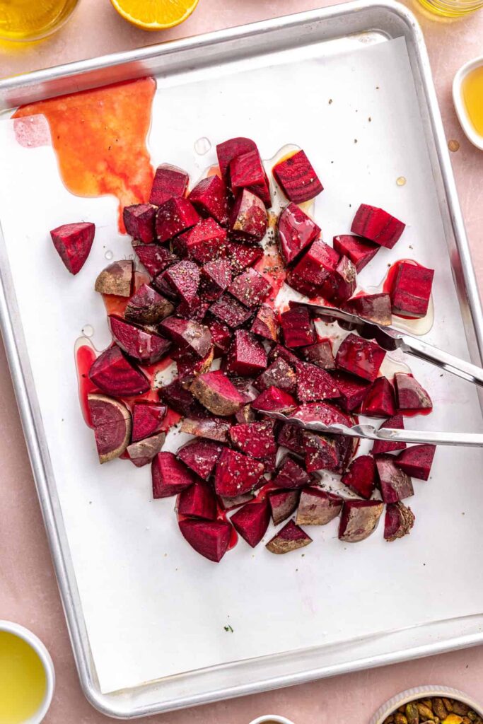 Fresh red beets chopped on a sheet pan for beet salad