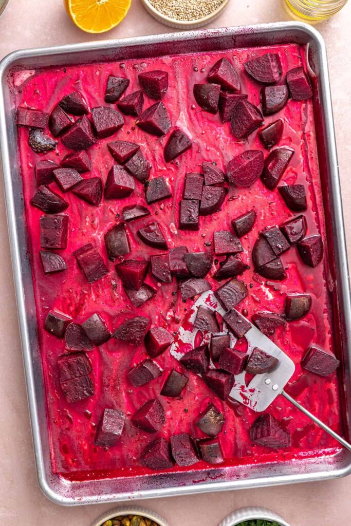 Tender roasted beets cooling on a sheet pan