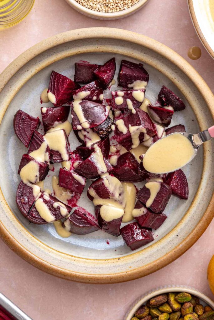 Mixing roasted beets with dressing for beet salad