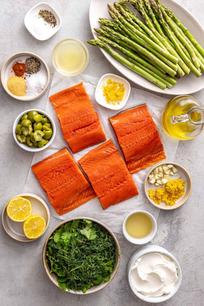 Ingredients for baked sheet pan salmon and asparagus arranged on a kitchen counter