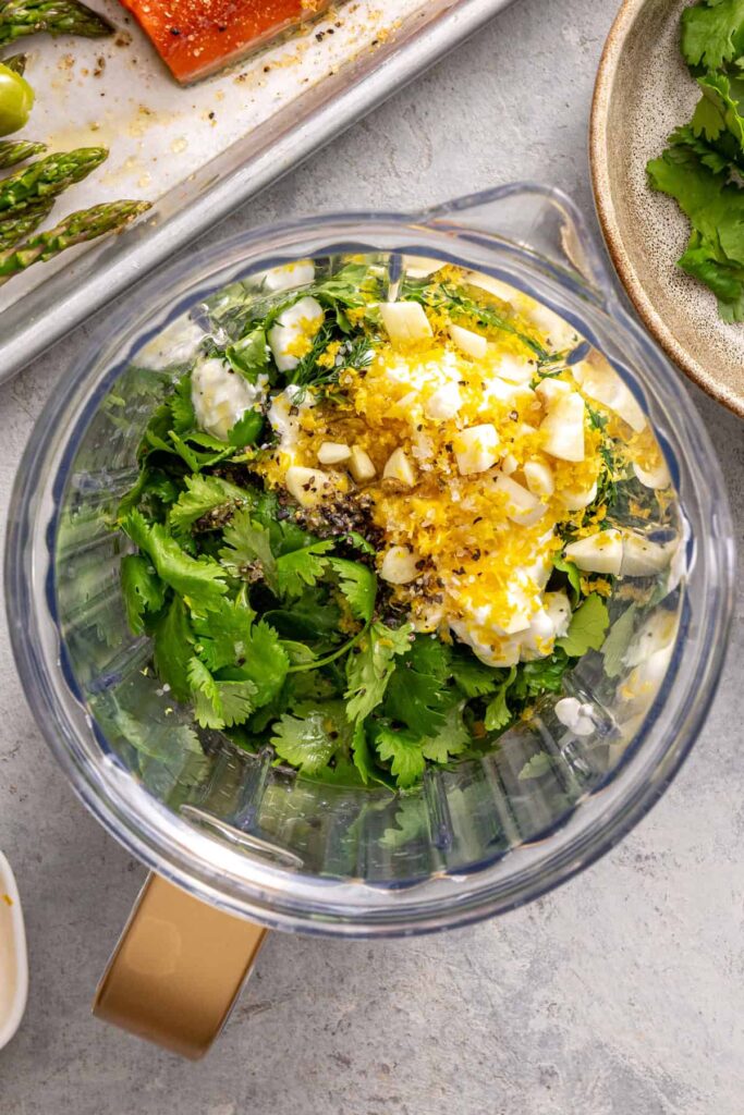 Ingredients for creamy herb yogurt sauce in blender