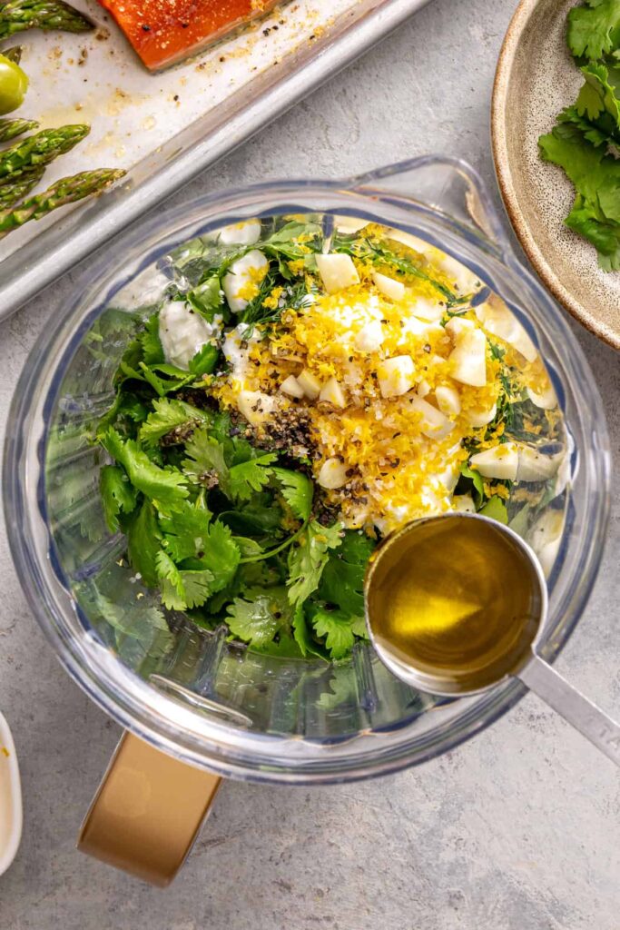 Fresh herbs, yogurt, garlic, and lemon added to blender for sauce