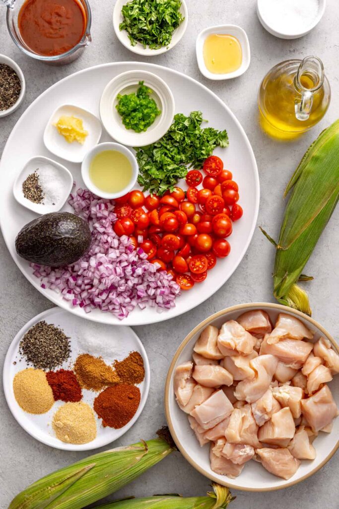 Ingredients for corn and tomato salad, an healthy bbq chicken skewers
