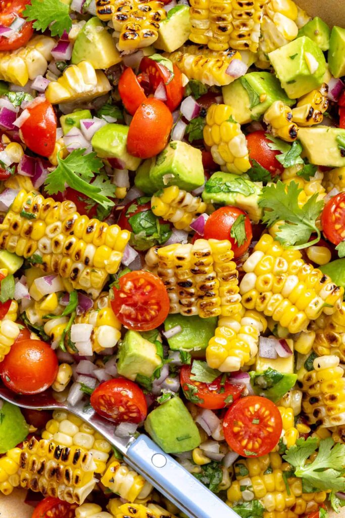 Detailed view of charred corn salad tossed in cilantro lime dressing