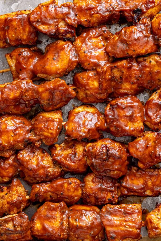 Close-up of juicy grilled BBQ chicken skewers with smoky seasoning