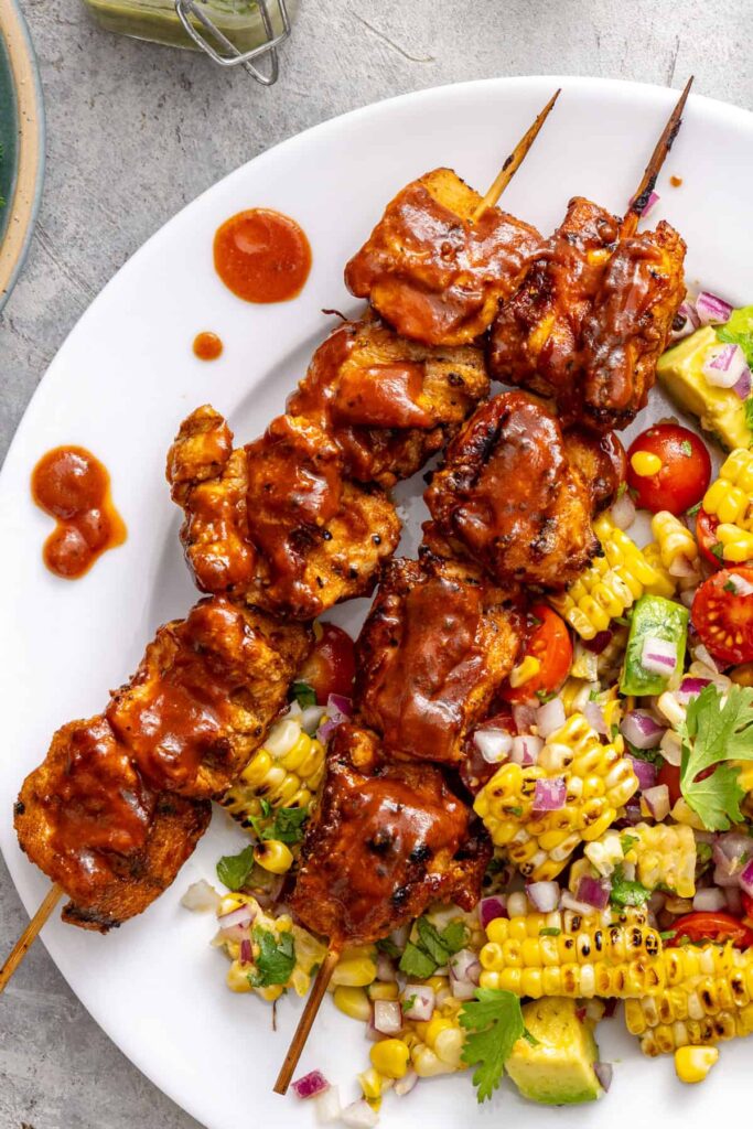 Macro-friendly BBQ chicken skewers with no sugar added BBQ sauce and a side salad
