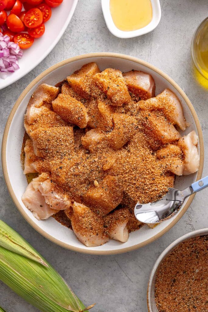 Seasoning chicken pieces for healthy grilled BBQ chicken skewers
