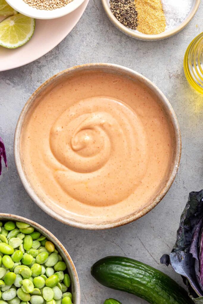 Creamy dairy-free bang bang sauce prepared for drizzling over crispy air fryer bang bang shrimp.