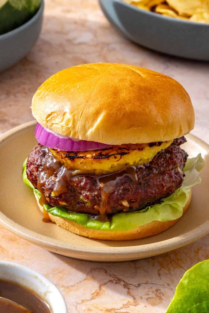 Thick grilled teriyaki burger on a gluten-free brioche bun