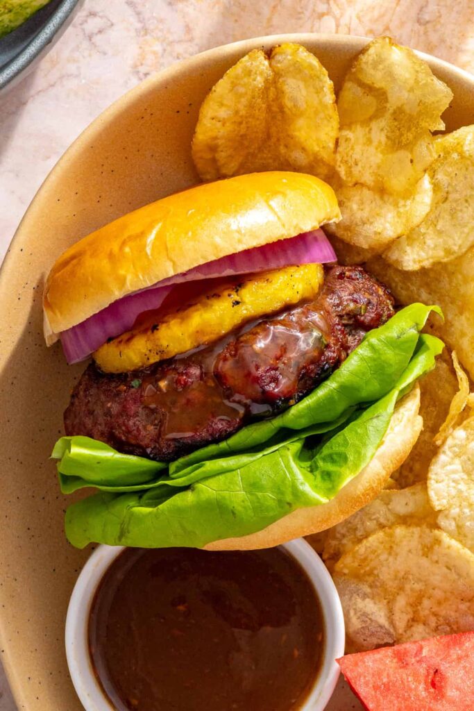 Hawaiian teriyaki burger meal served with chips and watermelon