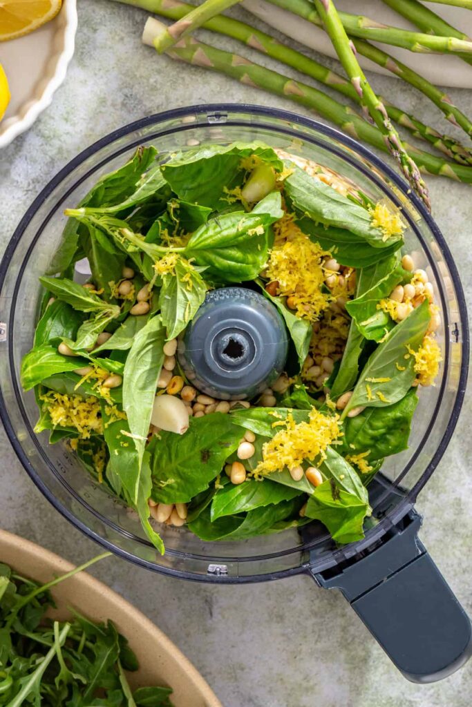 Basil, pine nuts, garlic, and lemon zest in a food processor for homemade lemon pesto