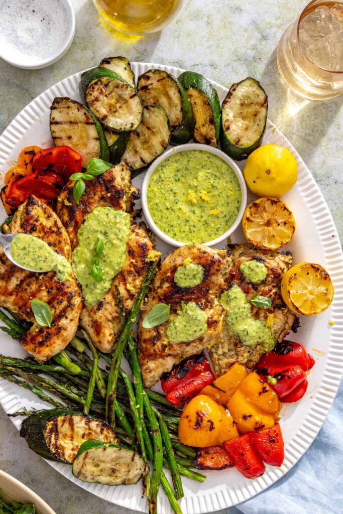 Grilled chicken with basil pesto, zucchini, asparagus, and bell peppers