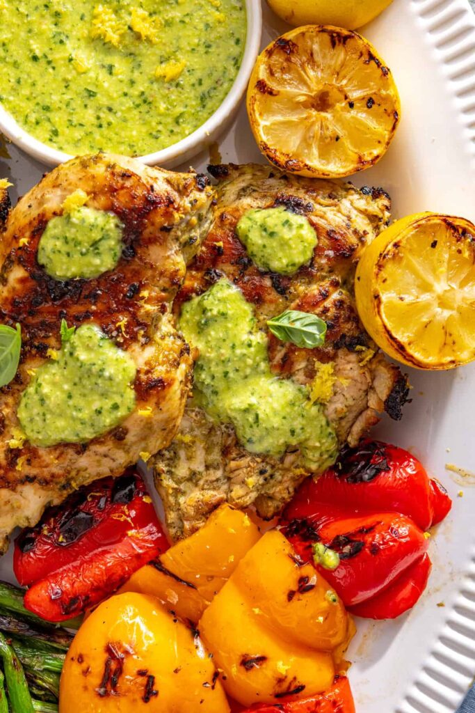 Healthy summer dinner spread with lemon pesto chicken and grilled vegetables