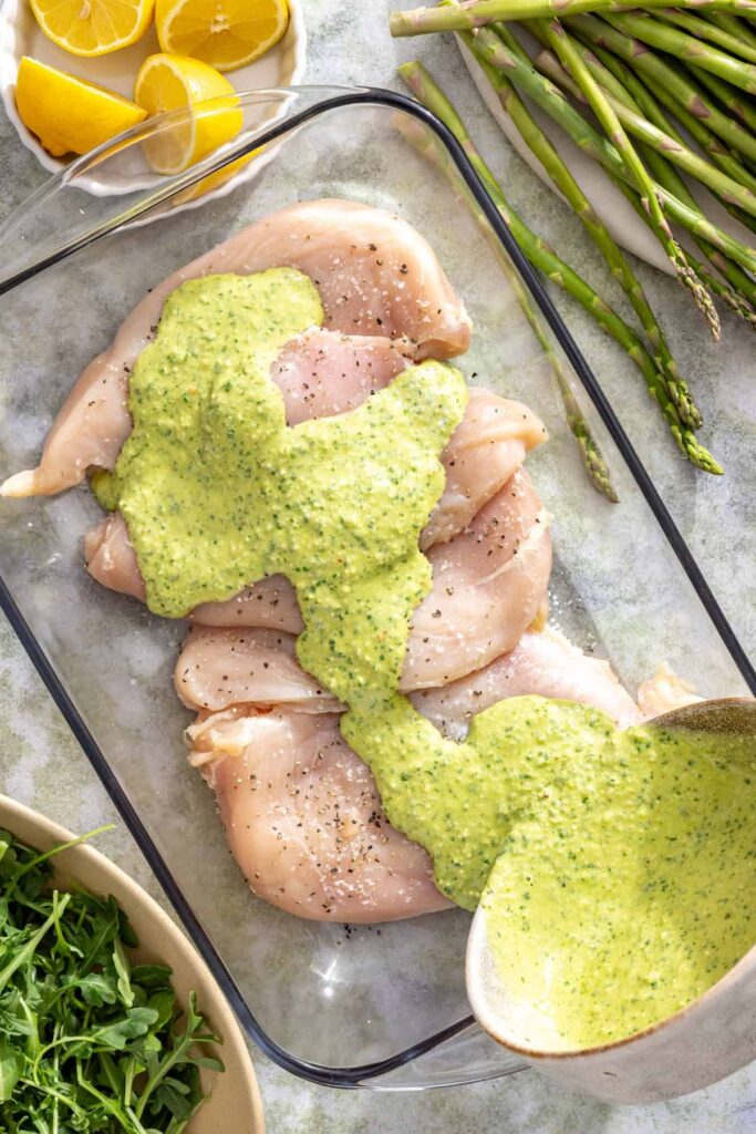 Lemon pesto chicken marinating for a healthy summer dinner