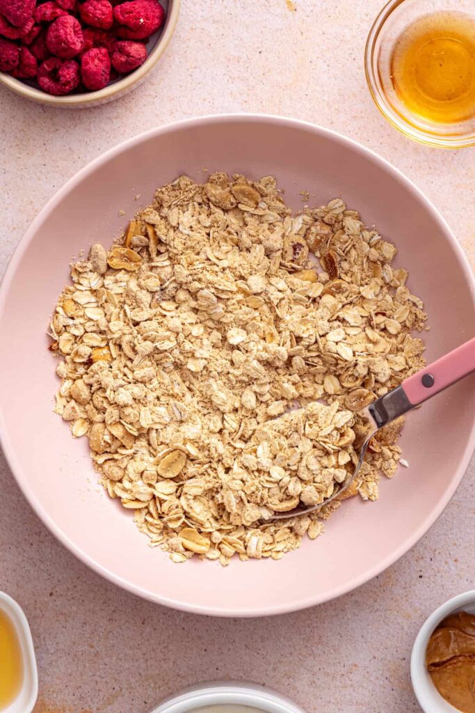 Mixing oats, chopped peanuts, PB2, and cinnamon for peanut butter crumble
