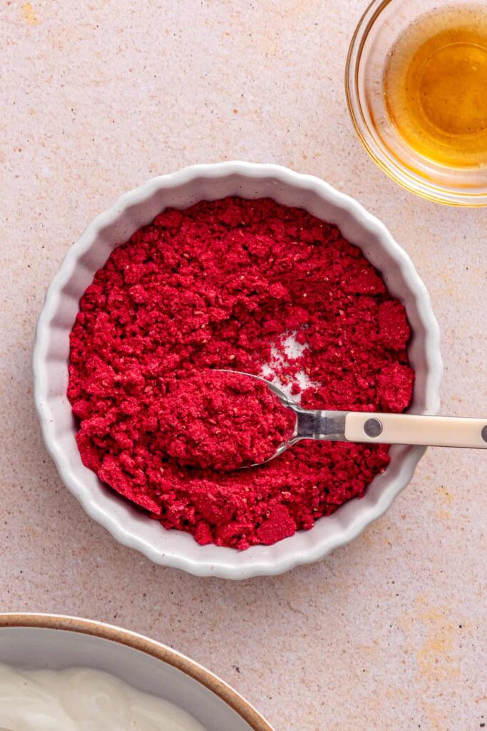 Crushing freeze-dried raspberries for the whipped yogurt topping
