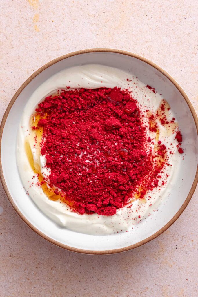 Whisking raspberry Greek yogurt topping