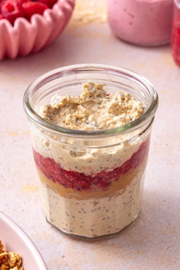 Peanut butter and jelly overnight oats assembled in meal prep jars