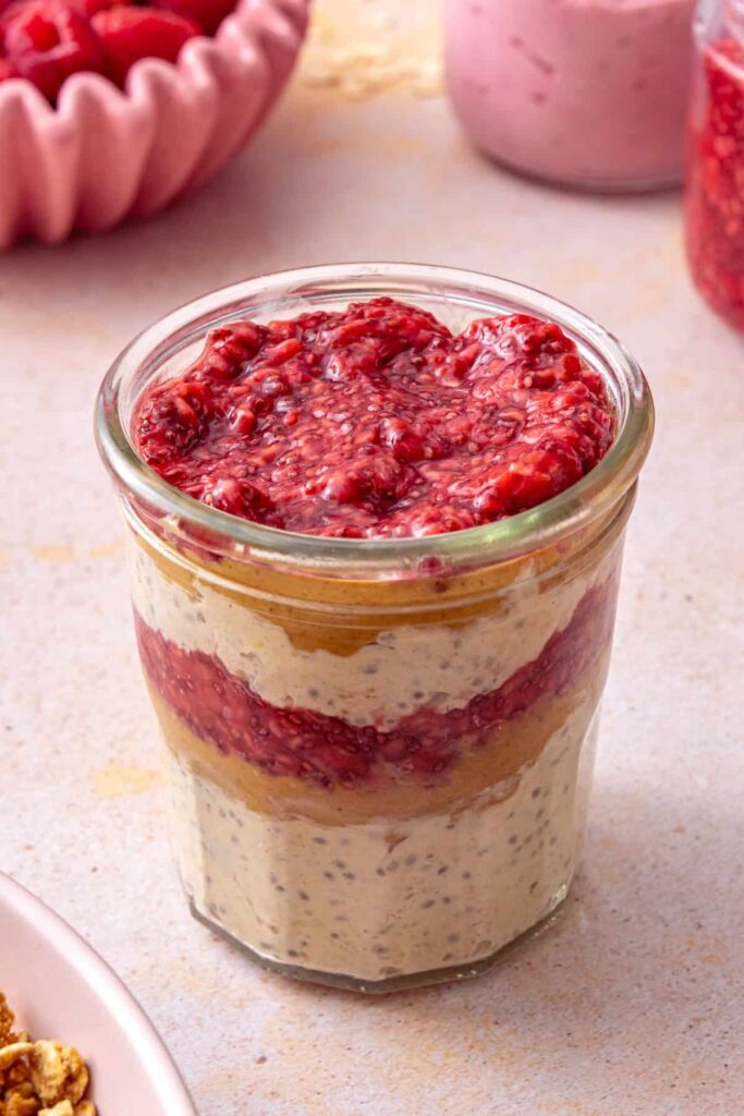 Peanut butter and jelly overnight oats assembled in meal prep jars