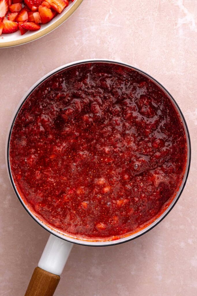 Homemade strawberry chia jam cooking on the stovetop.