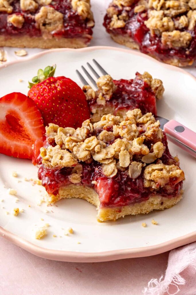 Single strawberry oatmeal bar served on a plate for breakfast or dessert.