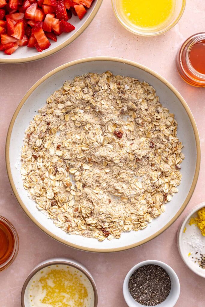 Mixing the oat crumble topping for homemade strawberry oatmeal bars.