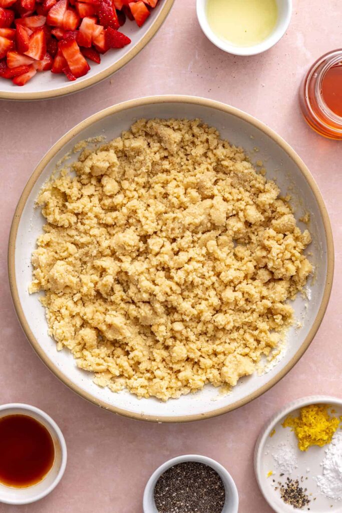 Preparing the buttery crust for healthy strawberry oatmeal bars.