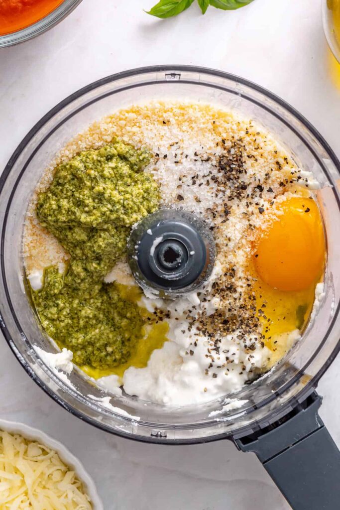Ricotta, cottage cheese, pesto, and parmesan blending into whipped filling for stuffed shells