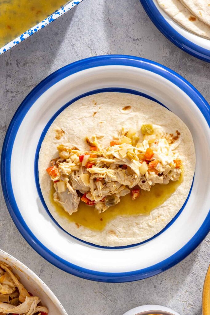 illing tortillas with creamy shredded chicken mixture for salsa verde enchiladas