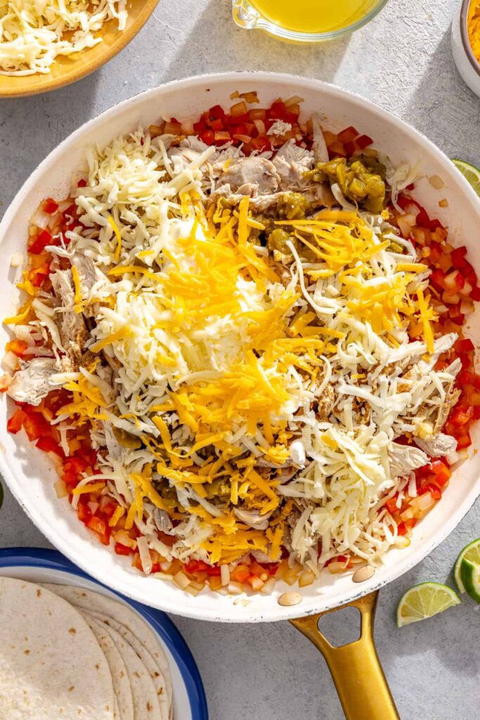 Creamy chicken enchilada filling mixed with shredded chicken, green chiles, cheese, and sour cream