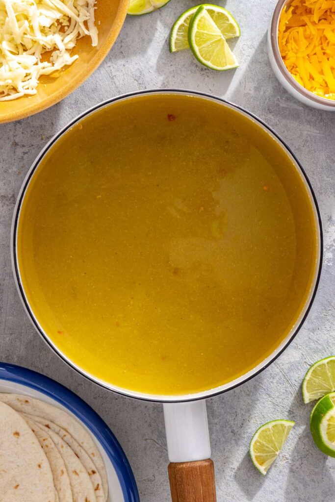Homemade creamy green enchilada sauce warming on the stove