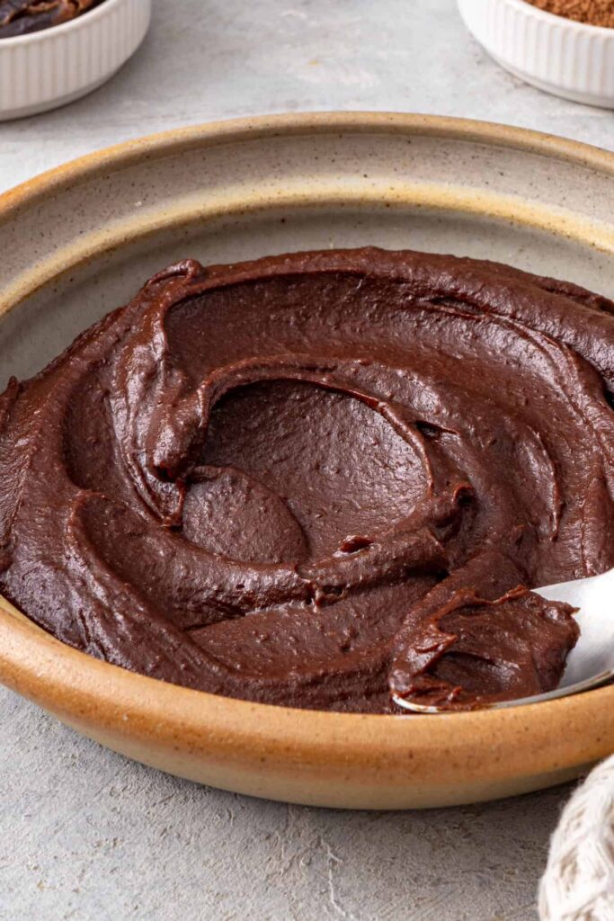 Rich chocolate date frosting showing its smooth texture