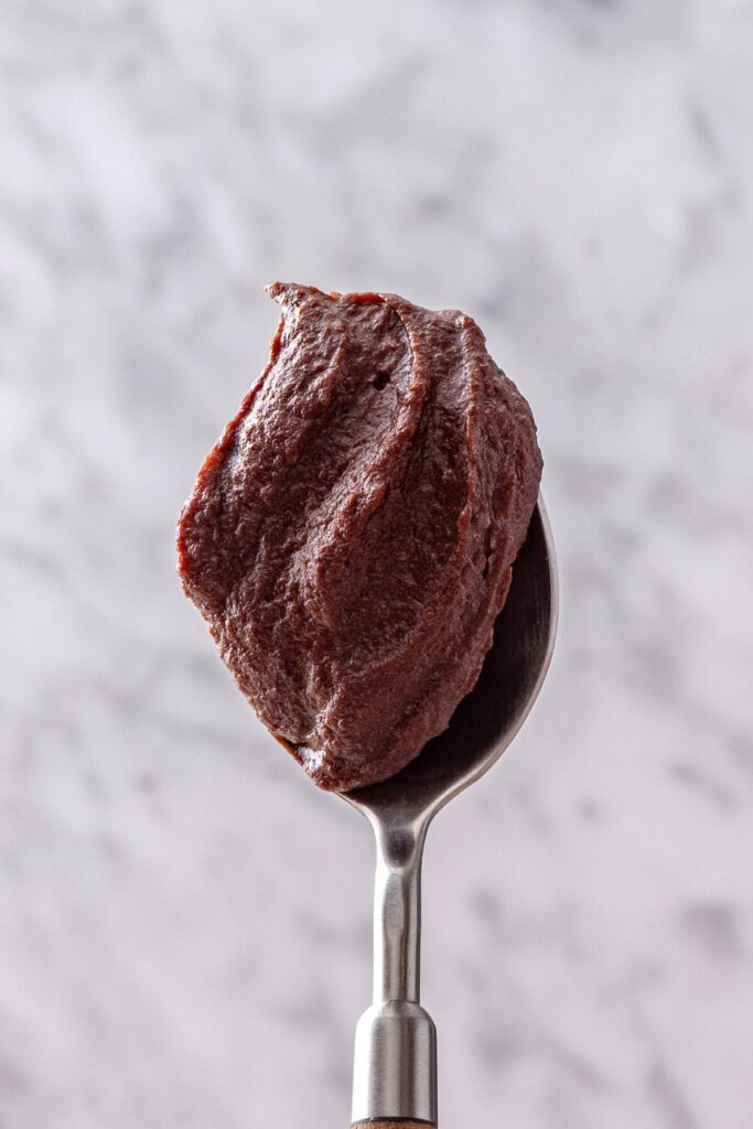 Spoonful of healthy chocolate frosting with a rich, creamy texture