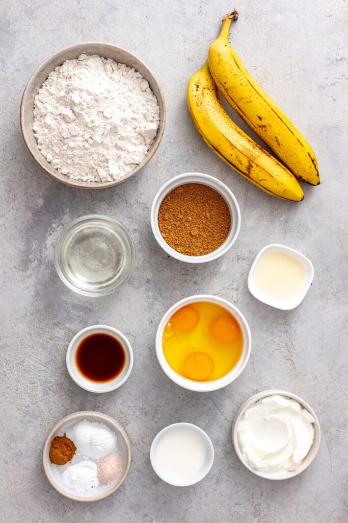 Ingredients for healthy banana birthday cake including ripe bananas, eggs, gluten-free flour and Greek yogurt
