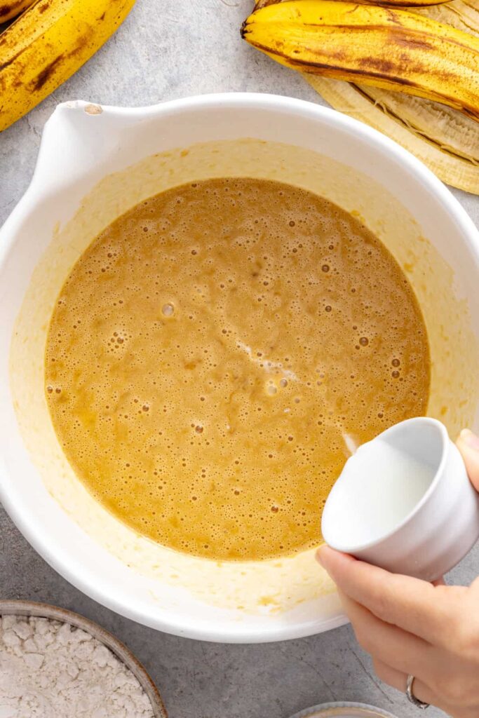 Adding coconut oil to healthy banana birthday cake batter
