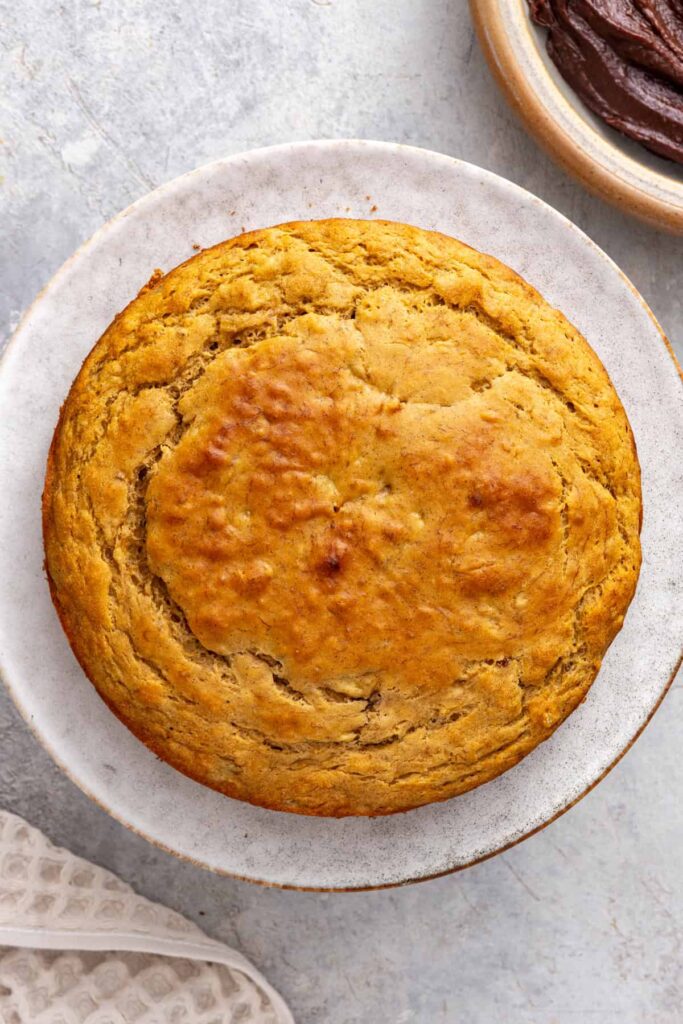 Healthy vanilla banana birthday cake on cake stand before frosting