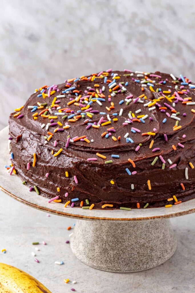 Homemade healthy banana birthday cake on a cake stand
