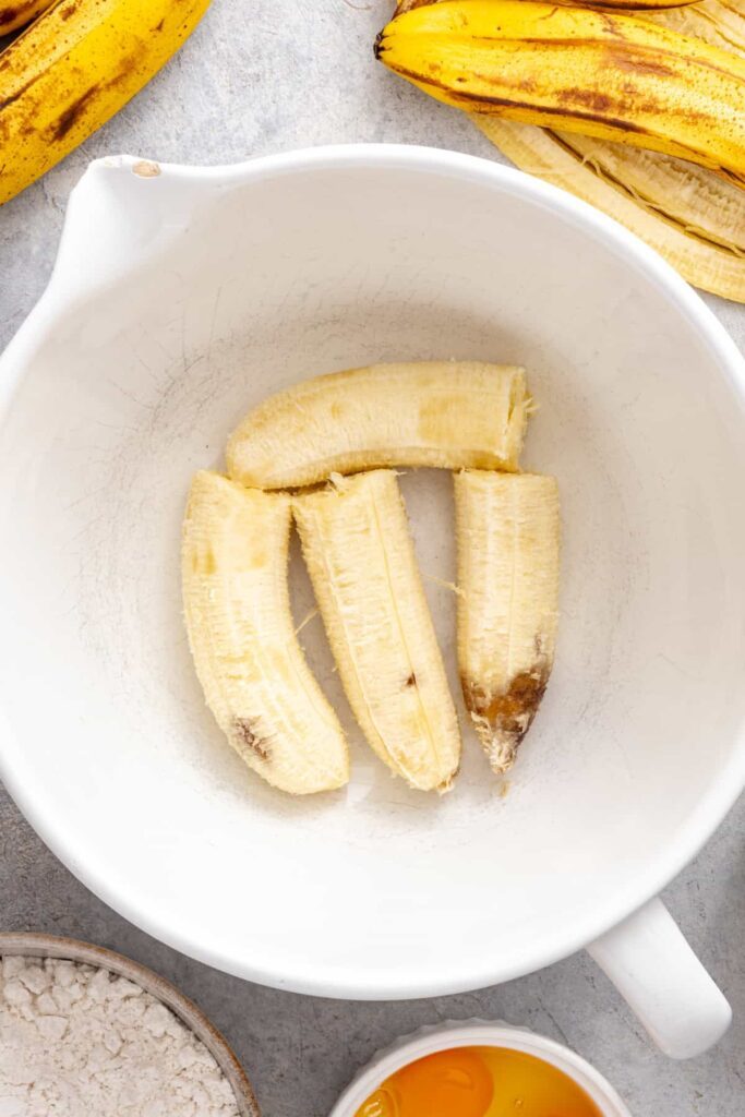ripe bananas in a bowl, ready to be mashed for a healthy banana cake
