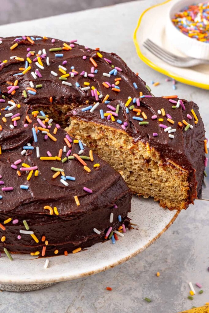 Slice of healthy banana birthday cake showing soft fluffy texture