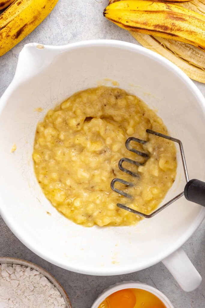 mashing ripe bananas for a healthy vanilla banana birthday cake batter