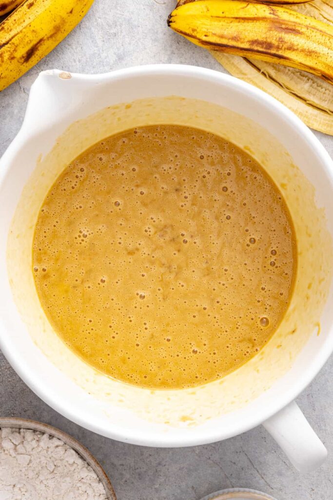 Banana cake wet ingredients combined in a large mixing bowl