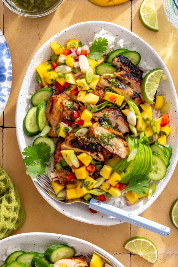 Serving honey lime grilled chicken with homemade cilantro-lime drizzle and mango salsa