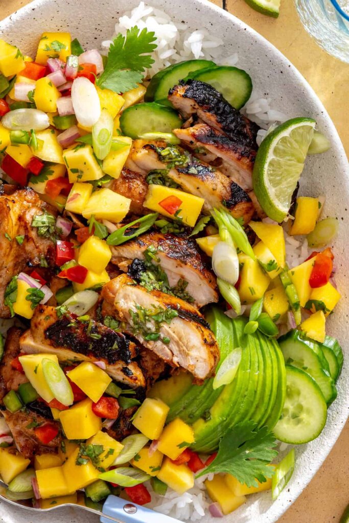 tight shot of honey lime grilled chicken with mango salsa and cilantro-lime drizzle