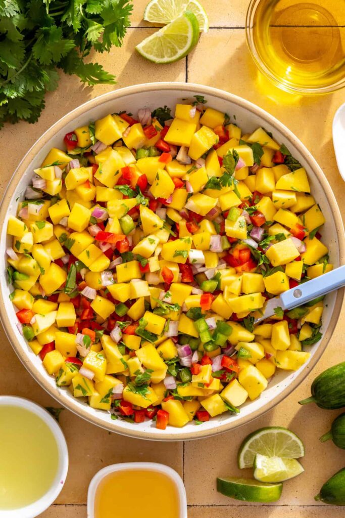 Fresh mango salsa with mango, red onion, cilantro, jalapeño, and bell pepper