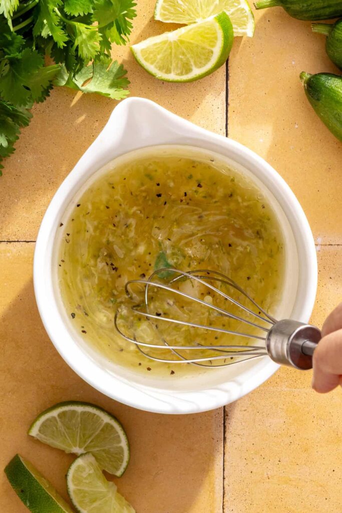Preparing cilantro-lime drizzle for honey lime grilled chicken