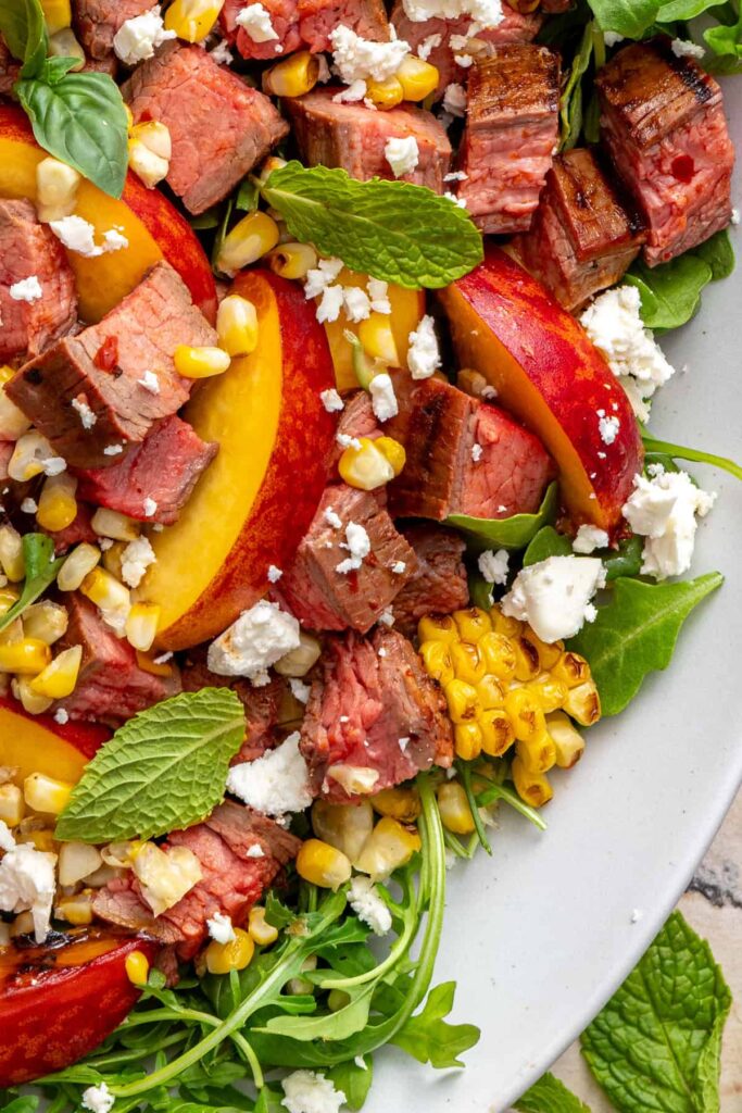 Vibrant grilled steak salad featuring juicy steak and summer produce